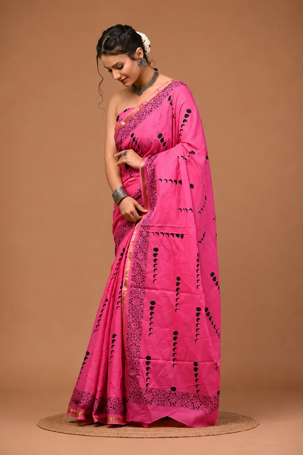 Vibrant Pink Crescent-Motif Saree with Intricate Border