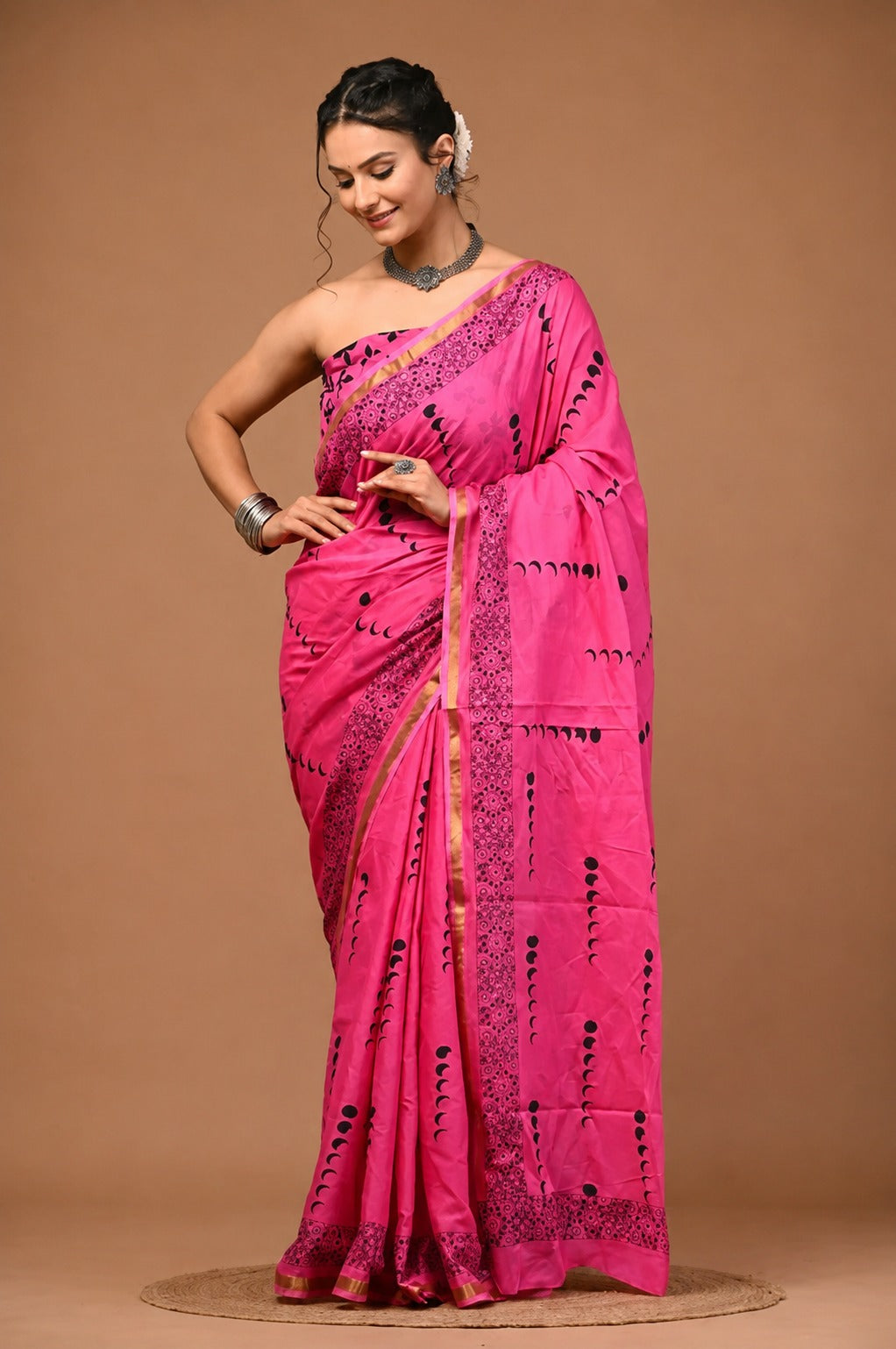 Vibrant Pink Crescent-Motif Saree with Intricate Border